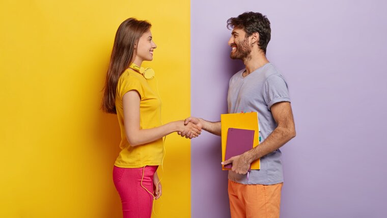 Two persons shaking hands in a friendly manner